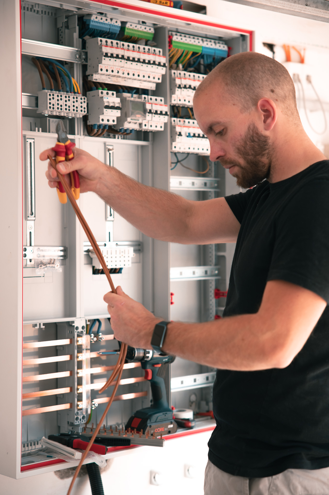 Electrician working on a distribution board during an installation